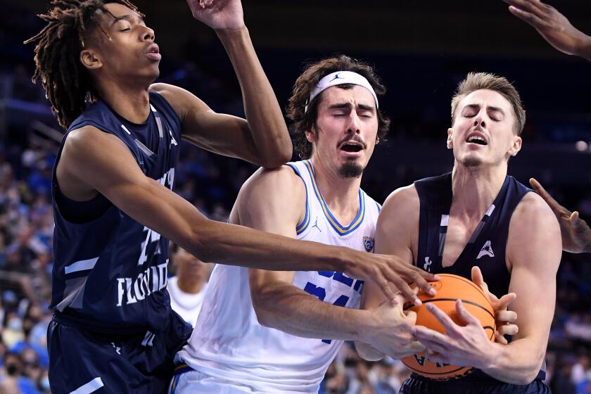 Los Angeles, California November 17, 2021: UCLA's Jaime Jaquez Jr. battles for rebound with North Florida's Jadyn Parker, left, and Carter Hendricksen in the second half at Pauley Pavilion Wednesday. (Wally Skalij/Los Angeles Times)