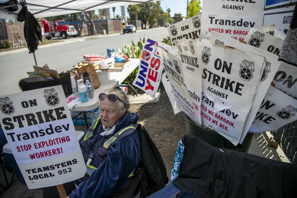 OC ACCESS driver Lydie Johnson takes a break from the picket line Friday outside the Irvine office of employer Transdev. 