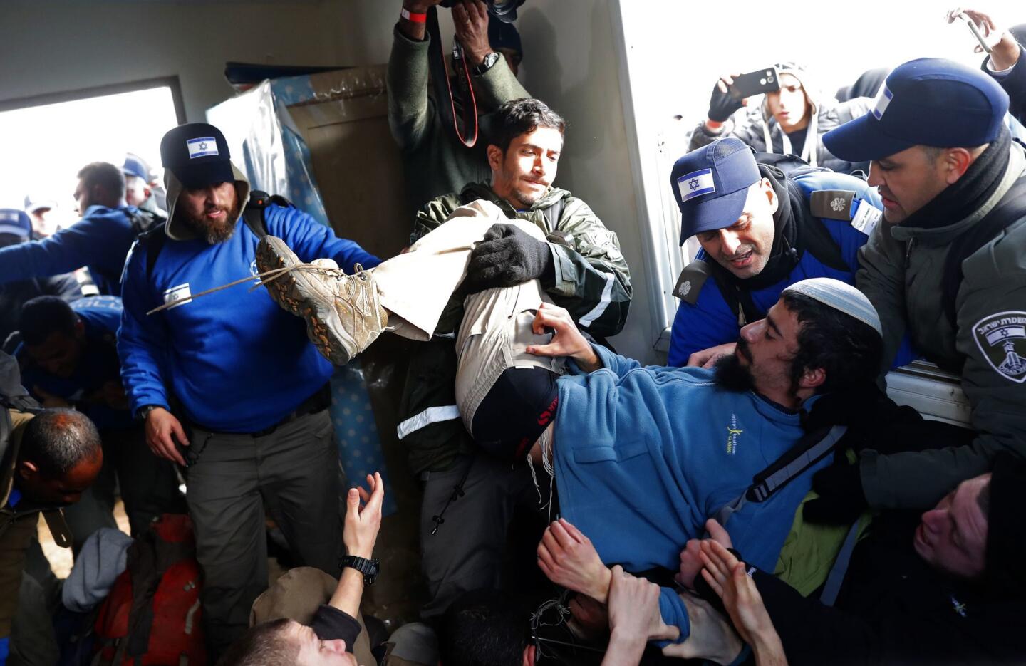 Residents of the West Bank village of Amona, which was built on private Palestinian land, are physically removed by Israeli security forces during eviction proceedings.