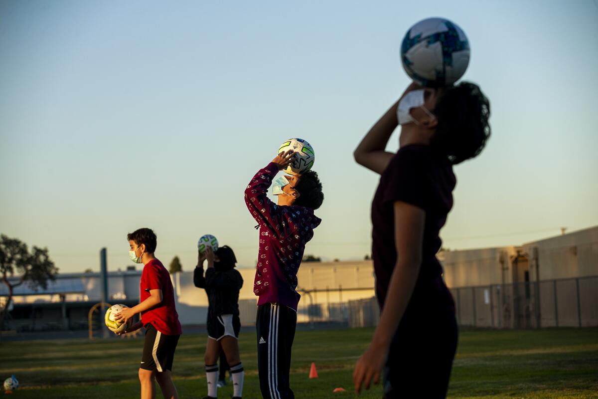 From left,  Andrew Arevalo, 12, Chelsea Vilchis, 13, Alex Vega, 16, and Angel Martinez, 15, participate in a soccer clinic.