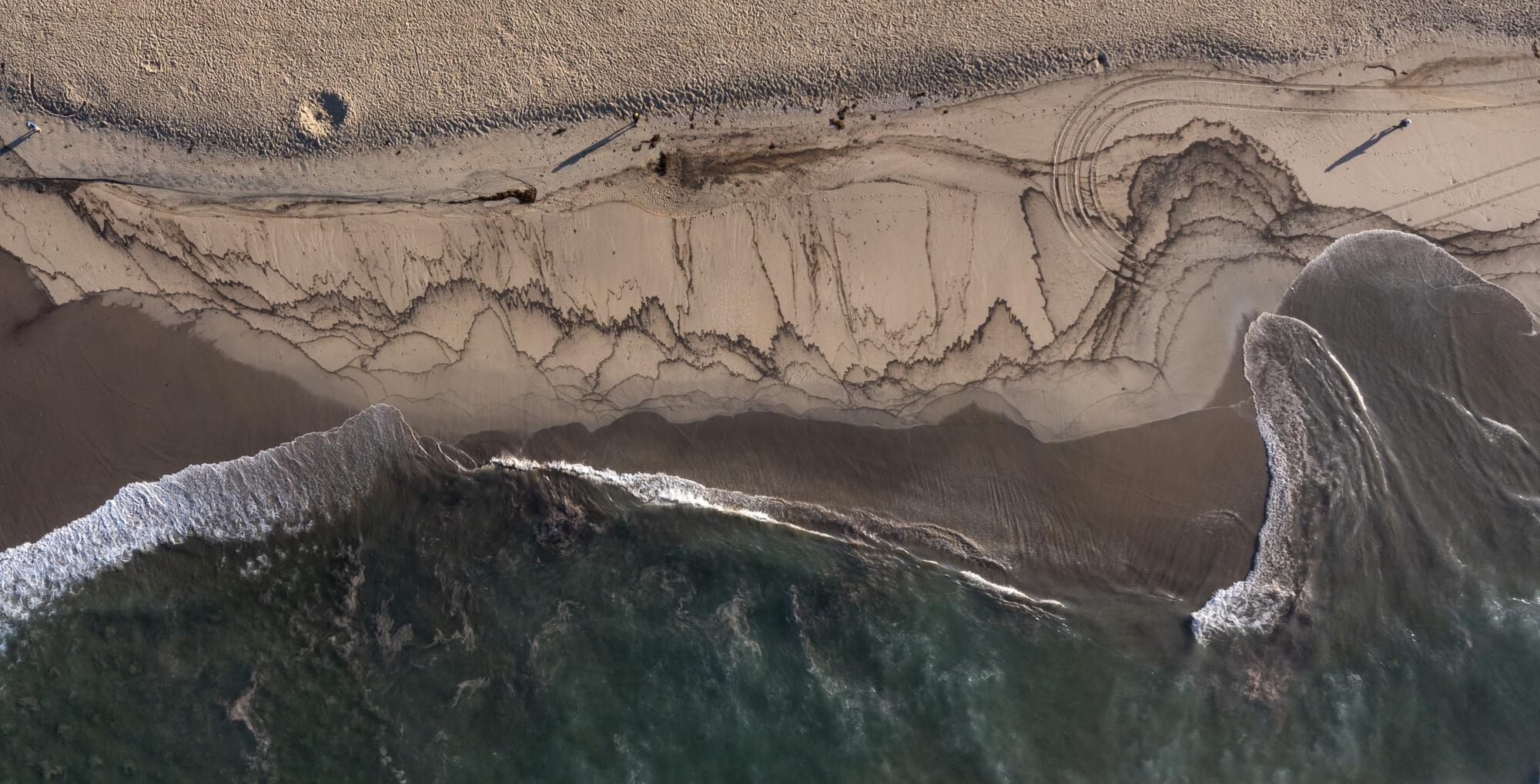 An aerial view of a major oil spill washing ashore on the border of Huntington Beach and Newport Beach.