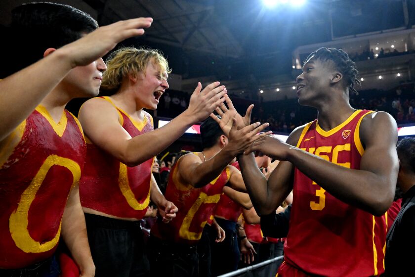 LOS ANGELES, CA - JANUARY 26: Vincent Iwuchukwu #3 of the USC Trojans celebrates with students after defeating the UCLA Bruins at Galen Center on January 26, 2023 in Los Angeles, California. (Photo by Jayne Kamin-Oncea/Getty Images)