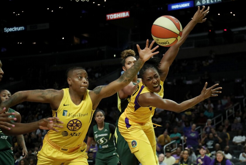 Sparks teammates Riquna Williams and Nneka Ogwumike chase after a rebound.