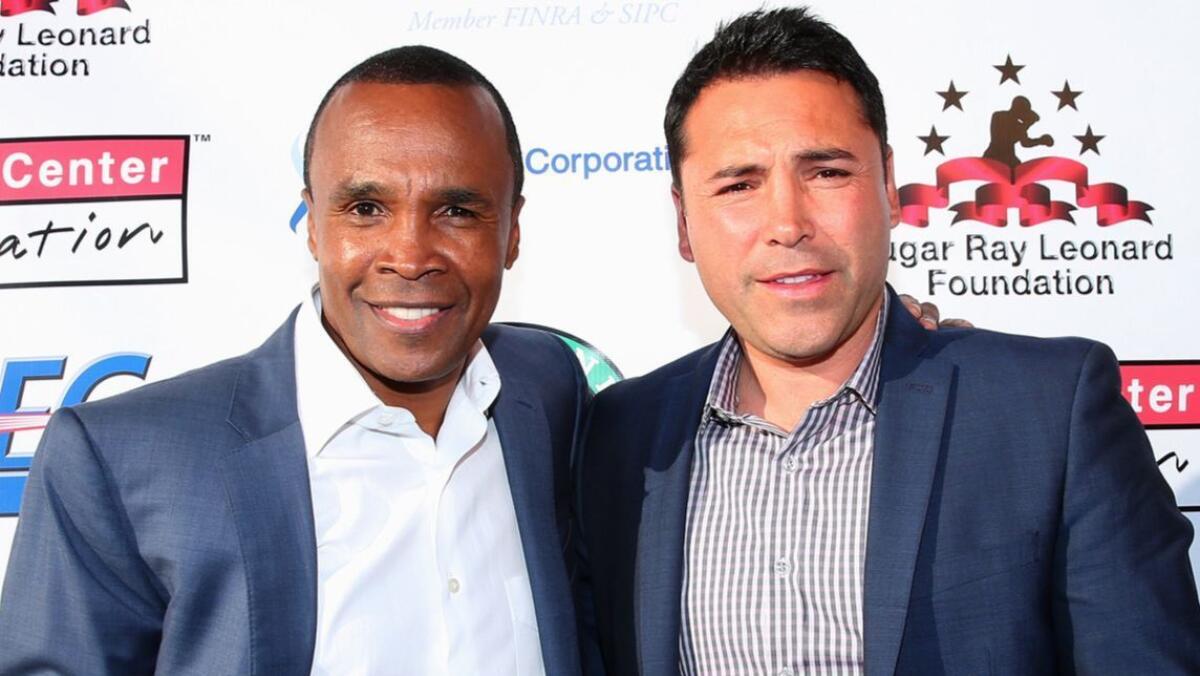 Sugar Ray Leonard and Oscar De La Hoya attend an event at the Santa Monica Pier on May 20, 2014.