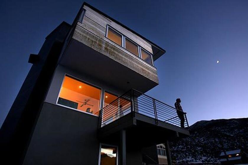 Tim Gallagher stands on the rear deck of his new home in Crowley Lake, a town about 15 minutes south of Mammoth Lakes. The house, designed by Tim's brother, Dan, is conceived as a series of stacked boxes sheathed in glass, cement board and corrugated metal that will require little maintenance. The result is a constructivist homage to the craggy peaks of Mammoth — and a departure from the traditional wood cabins that have long defined residential architecture in this region. Three bedrooms lie on the top floor, which cantilevers over the second floor and its public spaces: living room, kitchen and dining area. The bottom floor includes a rental apartment.