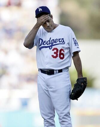 Dodgers pitcher Greg Maddux wipes his brow as the New York Mets scored 3 runs in the first inning.