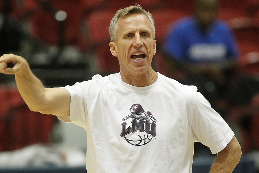 Loyola Marymount men's basketball Coach Mike Dunlap directs his players during a team scrimmage Friday.