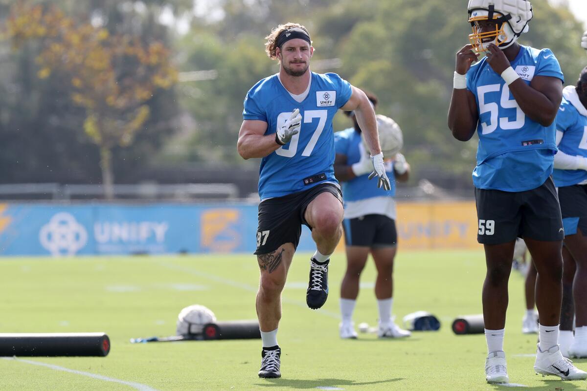 Linebacker Joey Bosa, left, warms up during the first day of Los Angeles Chargers training camp on Wednesday.