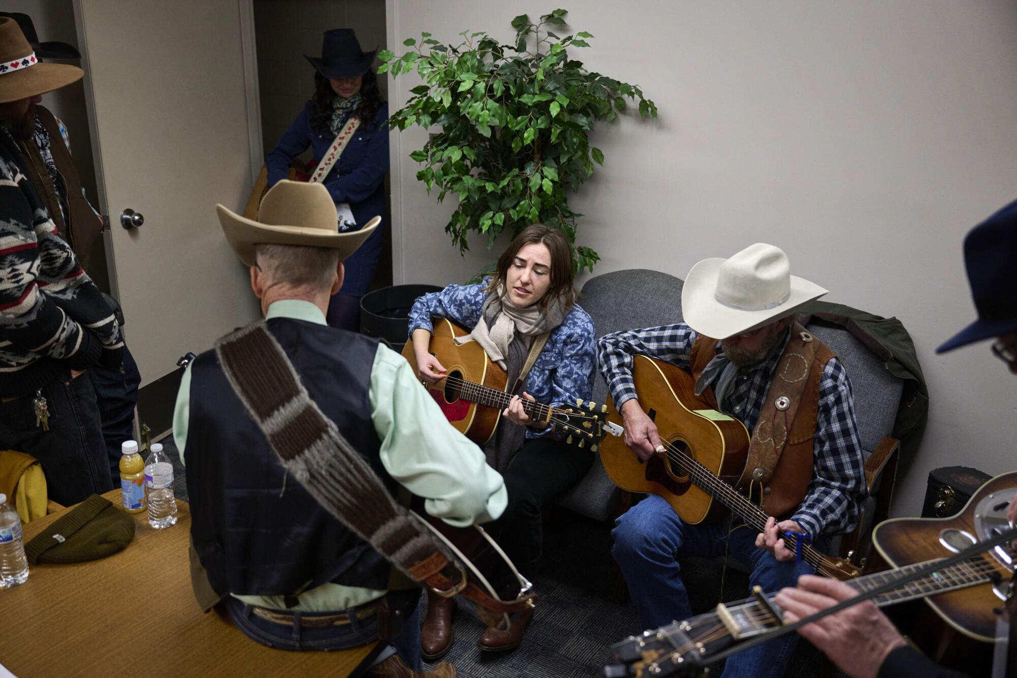 Margo Cilker, center, sings with other performers backstage at the National Cowboy Poetry Gathering.