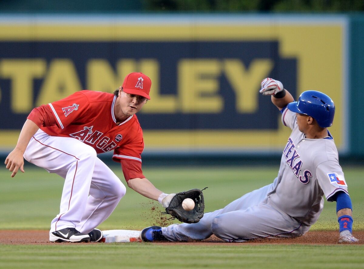 Texas Rangers outfielder Leonys Martin, left, gets under the tag of the Angels' Grant Green to steal second base during the Angels' 8-3 loss.