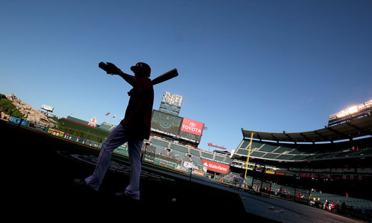 Angels outfielder Josh Hamilton gestures to fans at batting practice before Monday's season opener against the Seattle Mariners at Angel Stadium.