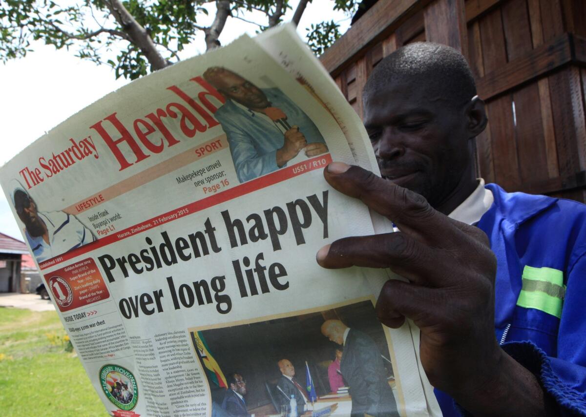 A man reads the state-owned newspaper The Herald in Harare, Zimbabwe's capital, ahead of the Feb. 21 feast marking the 91st birthday of President Robert Mugabe.