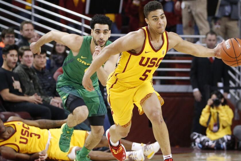 Southern California's Derryck Thornton (5) steals a ball from Oregon's Ehab Amin (4) during an NCAA college basketball game between Southern California and Oregon Thursday, Feb. 21, 2019, in Los Angeles. USC won 66-49. (AP Photo/Ringo H.W. Chiu)