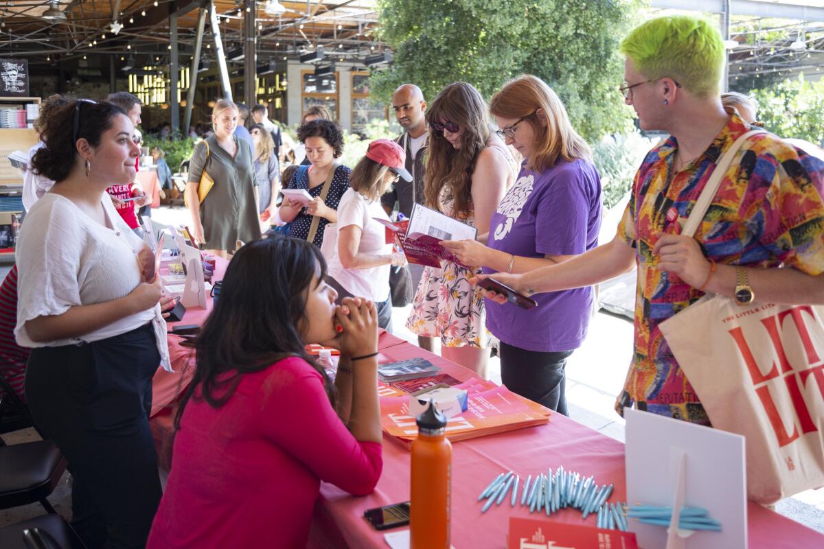 People browse booths at a book fair