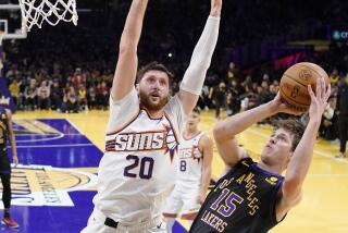 Lakers guard Austin Reaves, right, shoots as Suns center Jusuf Nurkic defends during Tuesday night's game.