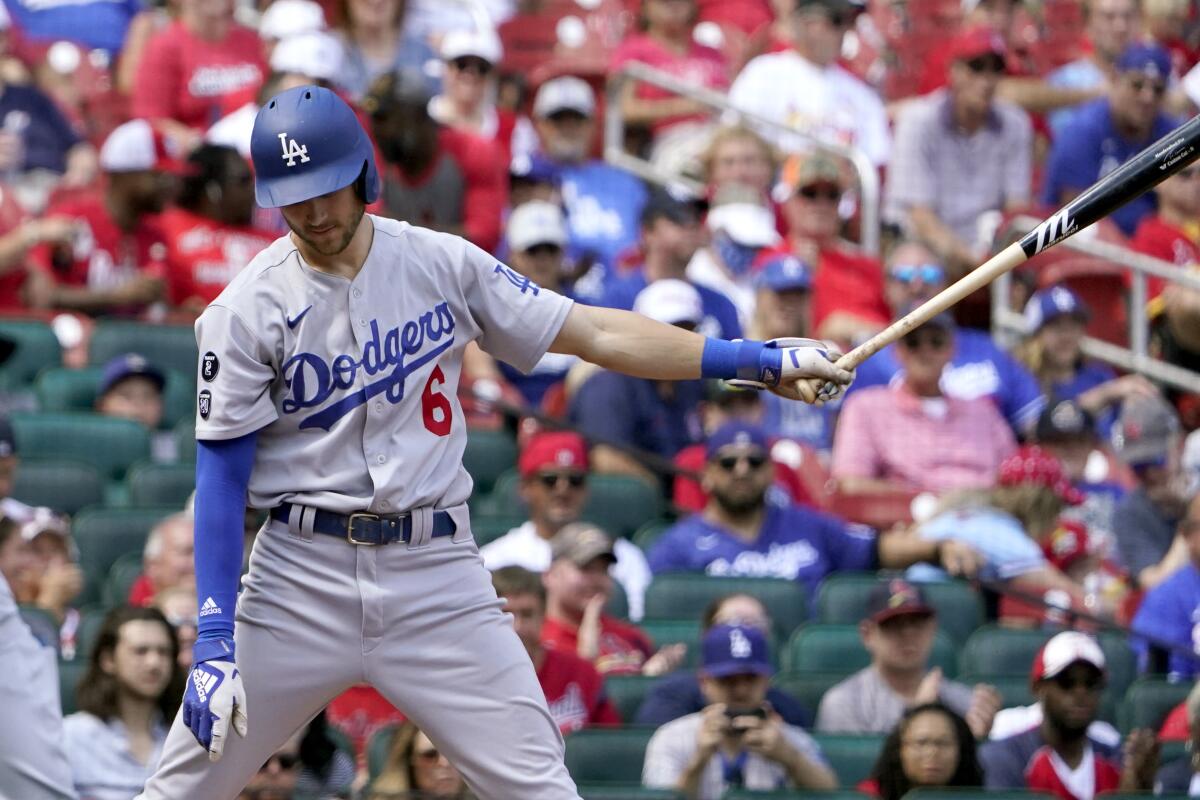 Los Angeles Dodgers' Trea Turner pauses at the plate after striking out swinging.