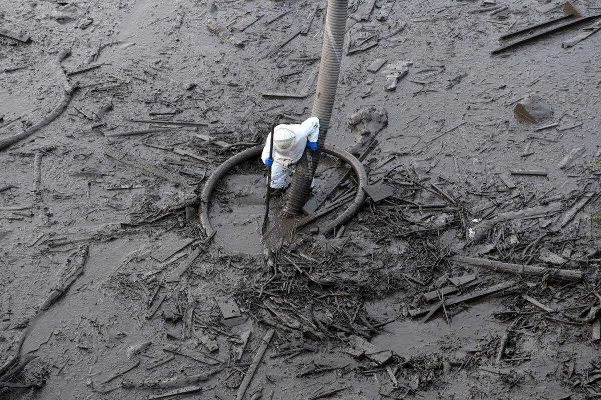 Work crews continue cleaning mud from the 101 Freeway in Montecito.