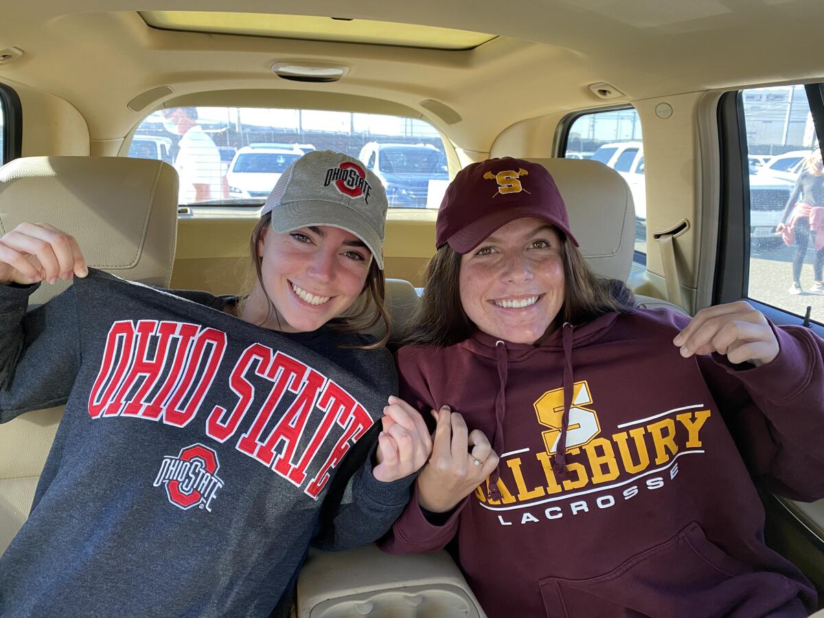 Vikings Stella Wineman and Ari Conboy sport their college sweatshirts on their way to a drive-in National Signing Day event.