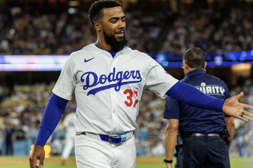 LOS ANGELES, CA - JULY 22, 2024: Los Angeles Dodgers outfielder Teoscar Hernandez (37) gets congrats at the dugout after his RBI single scored the go-ahead run against the San Francisco Giants in the eighth inning at Dodgers Stadium on July 22, 2024 in Los Angeles, California.(Gina Ferazzi / Los Angeles Times)