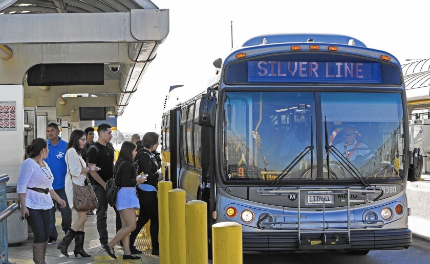Commuters board the Silver Line bus at the Manchester station on the Harbor Transitway in Los Angeles. Ridership has increased on the Silver Line recently.