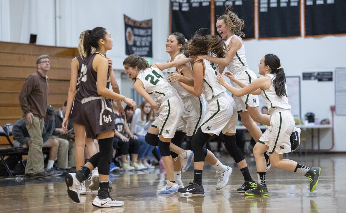 Sage Hill teammates mob Emily Elliott, center, after she hit a game-winning shot at the buzzer to beat Laguna Hills in an Ultimate Flight game at the Hawk Holiday Classic at Los Amigos High on Dec. 7, 2018.