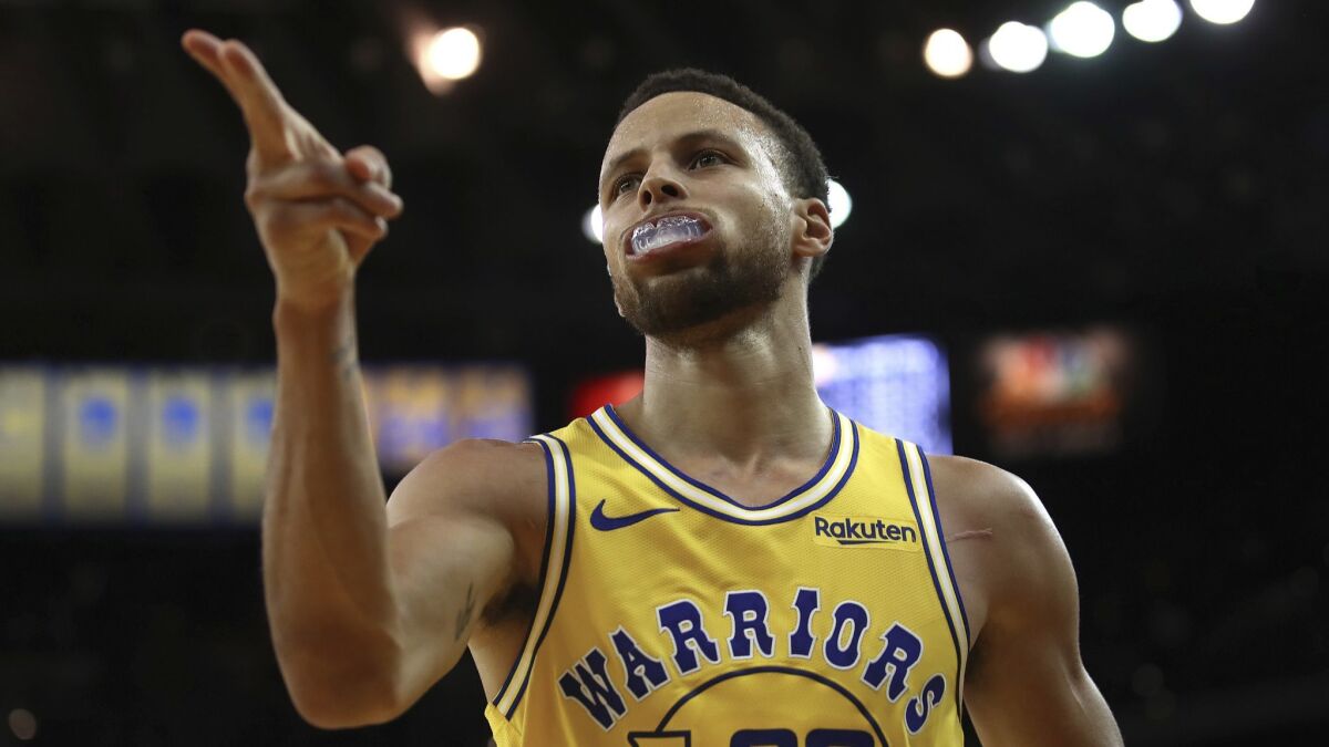 The Golden State Warriors' Stephen Curry celebrates a score against the Washington Wizards during their Oct. 24 game in Oakland.