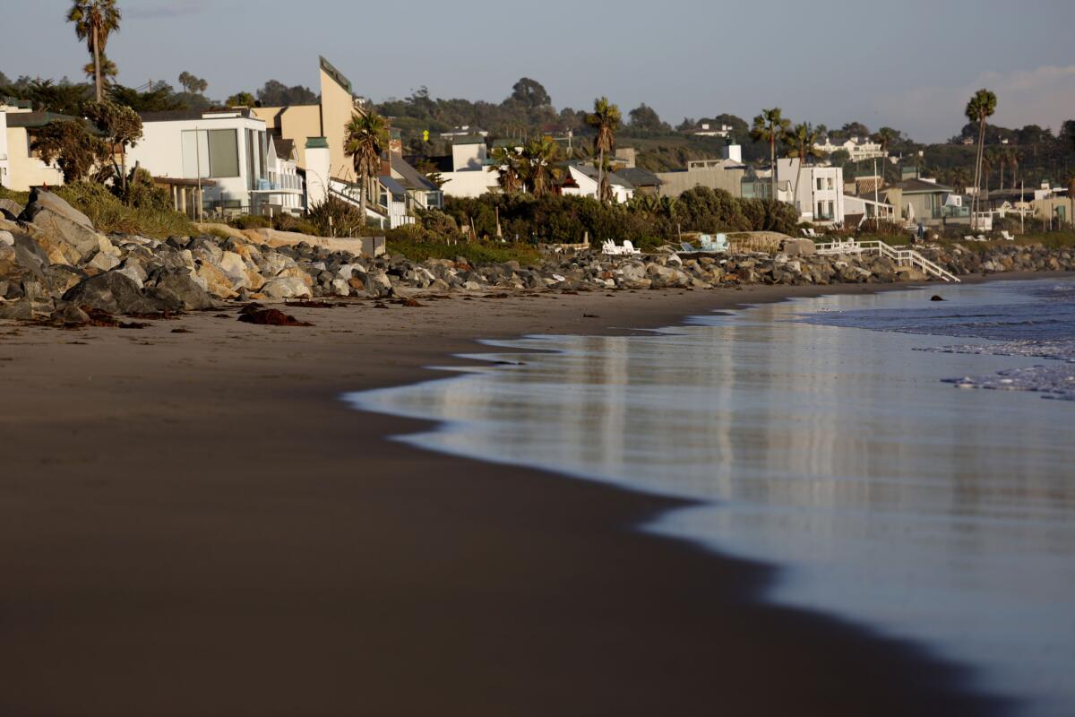 High tides in the coming days are expected to be higher than usual. Above, the waves stay away from homes along Malibu's Broad Beach on Oct. 20.