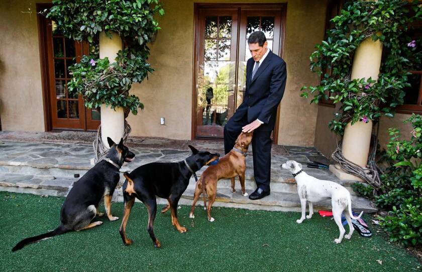 Dr. Gary Michelson at home in Los Angeles with his dogs. As a medical student, Michelson objected to learning surgery by operating on live dogs. Today, he is the sponsor of the Michelson Prize in Reproductive Biology, which offers $25 million for the first researcher to create an easy, affordable means of sterilizing animals.