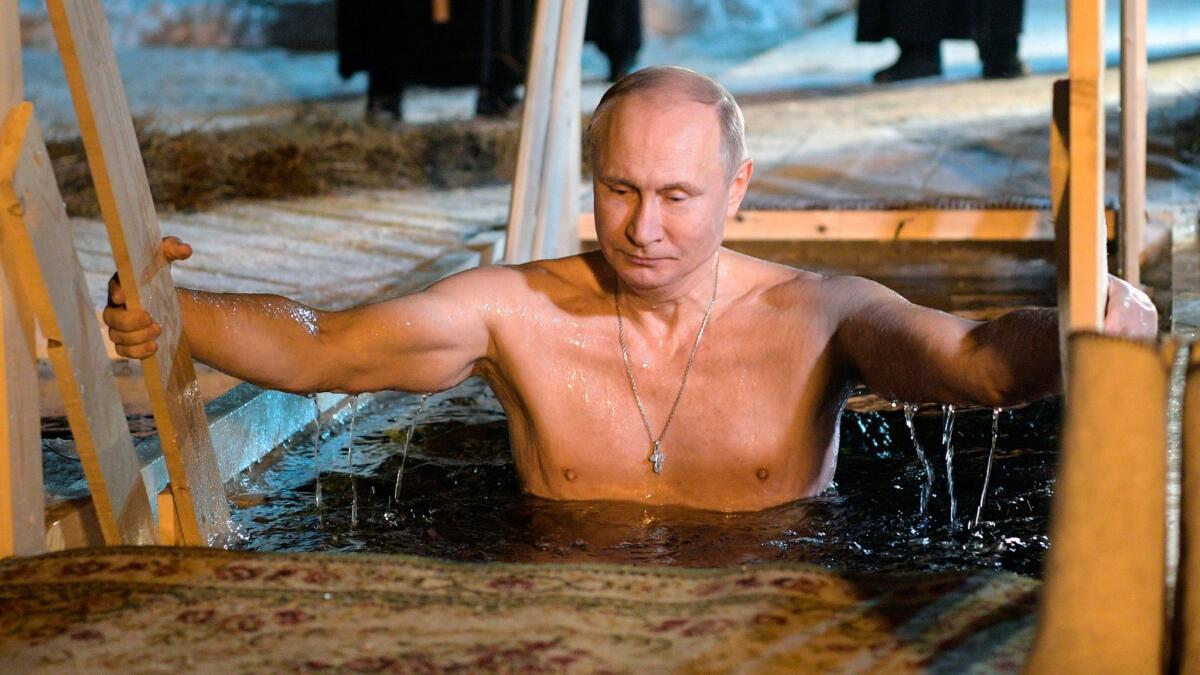 Russian President Vladimir Putin bathes in icy water near St. Nilus Stolobensky Monastery on Lake Seliger in Svetlitsa village, Russia, on Jan. 19, 2018.