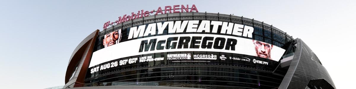 Advertisements for the bout between boxer Floyd Mayweather Jr. and UFC lightweight champion Conor McGregor are displayed on the side of T-Mobile Arena on Aug. 24 in Las Vegas.