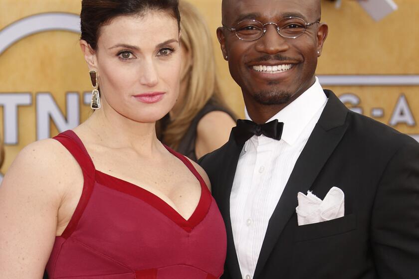 Idina Menzel and Taye Diggs arrive at the 19th Annual Screen Actors Guild Awards at the Shrine Auditorium in Los Angeles on Sunday Jan. 27, 2013. (Photo by Todd Williamson/Invision for The Hollywood Reporter/AP Images)