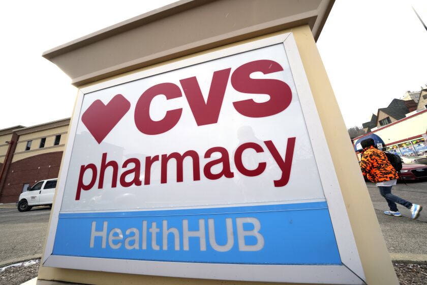 A CVS store sign is displayed in Pittsburgh on Friday, Feb. 3, 2023. CVS Health is plunging deeper into primary care services, buying Oak Street Health for approximately $10.6 billion. The drugstore chain said Wednesday, Feb. 8, 2023, it would pay $39 per share in cash for each share of Oak Street Health in a deal expected to close this year. (AP Photo/Gene J. Puskar)