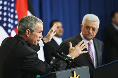 President Bush speaks at a news conference in Ramallah, in the West Bank, as Palestinian Authority President Mahmoud Abbas looks on.