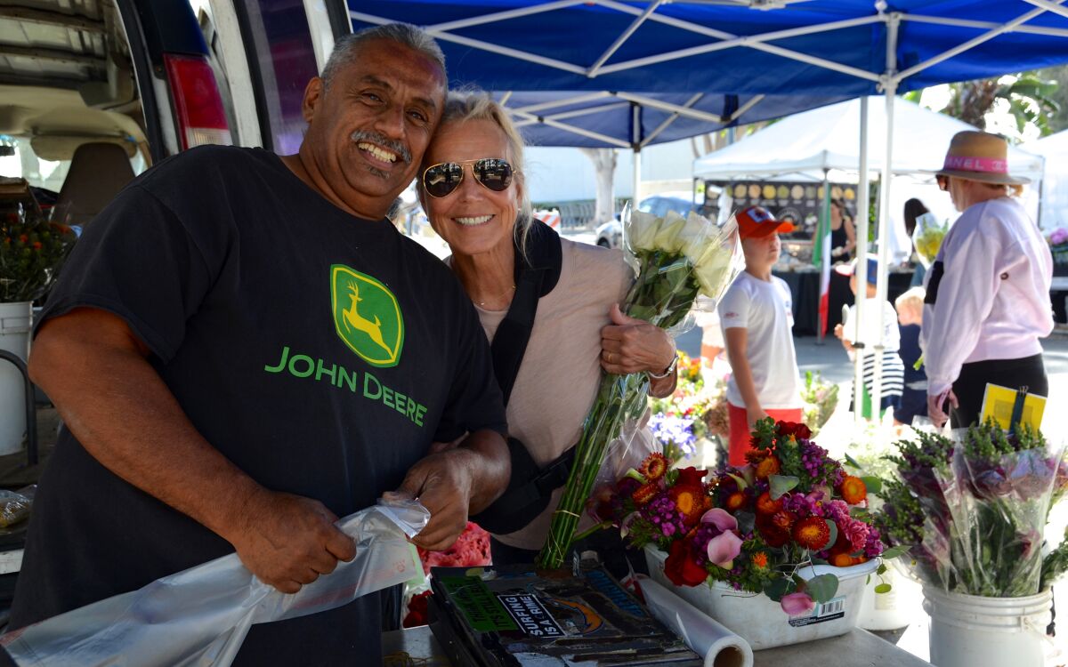 Flower Farmer, David Franco is grateful for loyal customers like Judy Busby who shop at the Corona del Mar farmers market.
