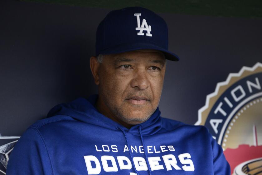 Los Angeles Dodgers manager Dave Roberts talks to reporters before a baseball game against the Washington Nationals