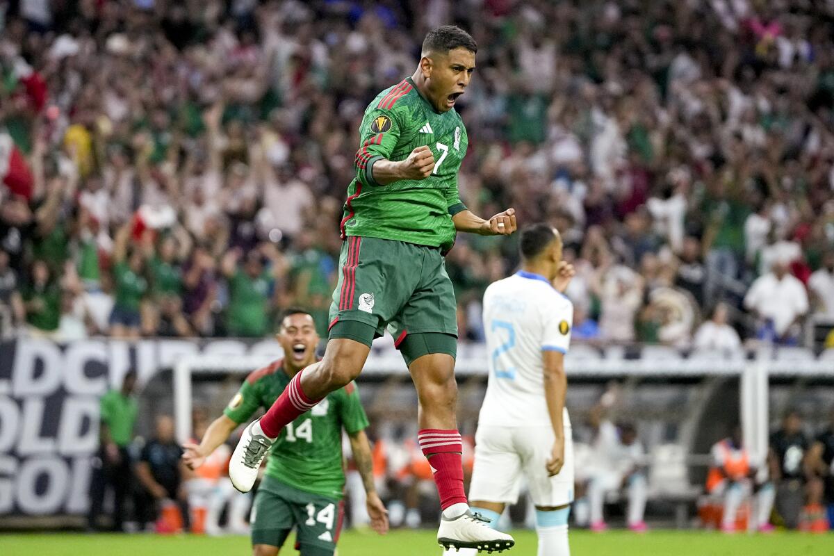 Mexico's Luis Romo leaps in celebration after scoring a goal in a 4-0 victory over Honduras.