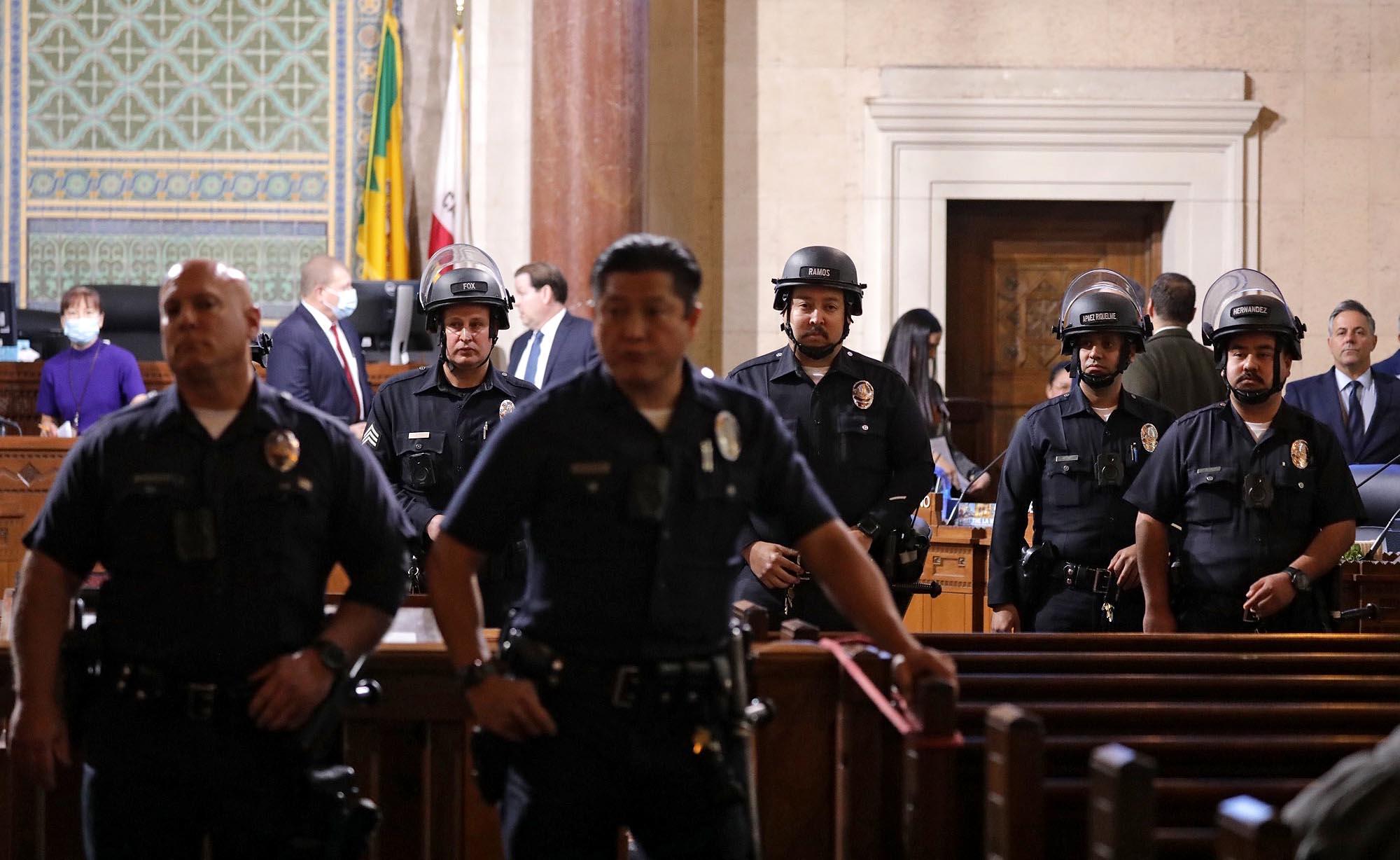 LAPD officers stand guard after the Los Angeles City Council chambers went into recess.