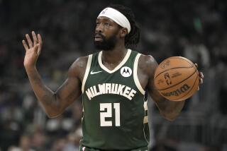 Milwaukee Bucks' Patrick Beverley holds up his hands while the ball in his left hand