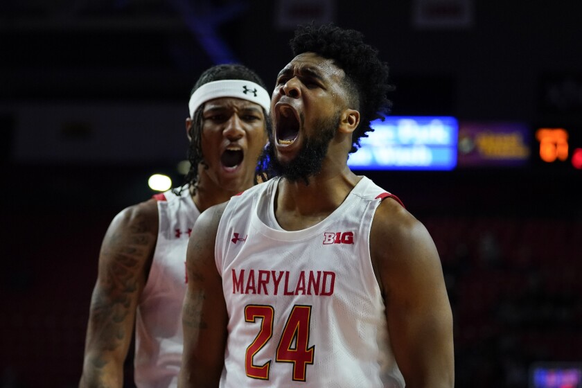 Maryland forward Donta Scott (24) and forward Julian Reese react after Scott scored a basket against Illinois during the second half of an NCAA college basketball game, Friday, Jan. 21, 2022, in College Park, Md. Maryland won 81-65. (AP Photo/Julio Cortez)