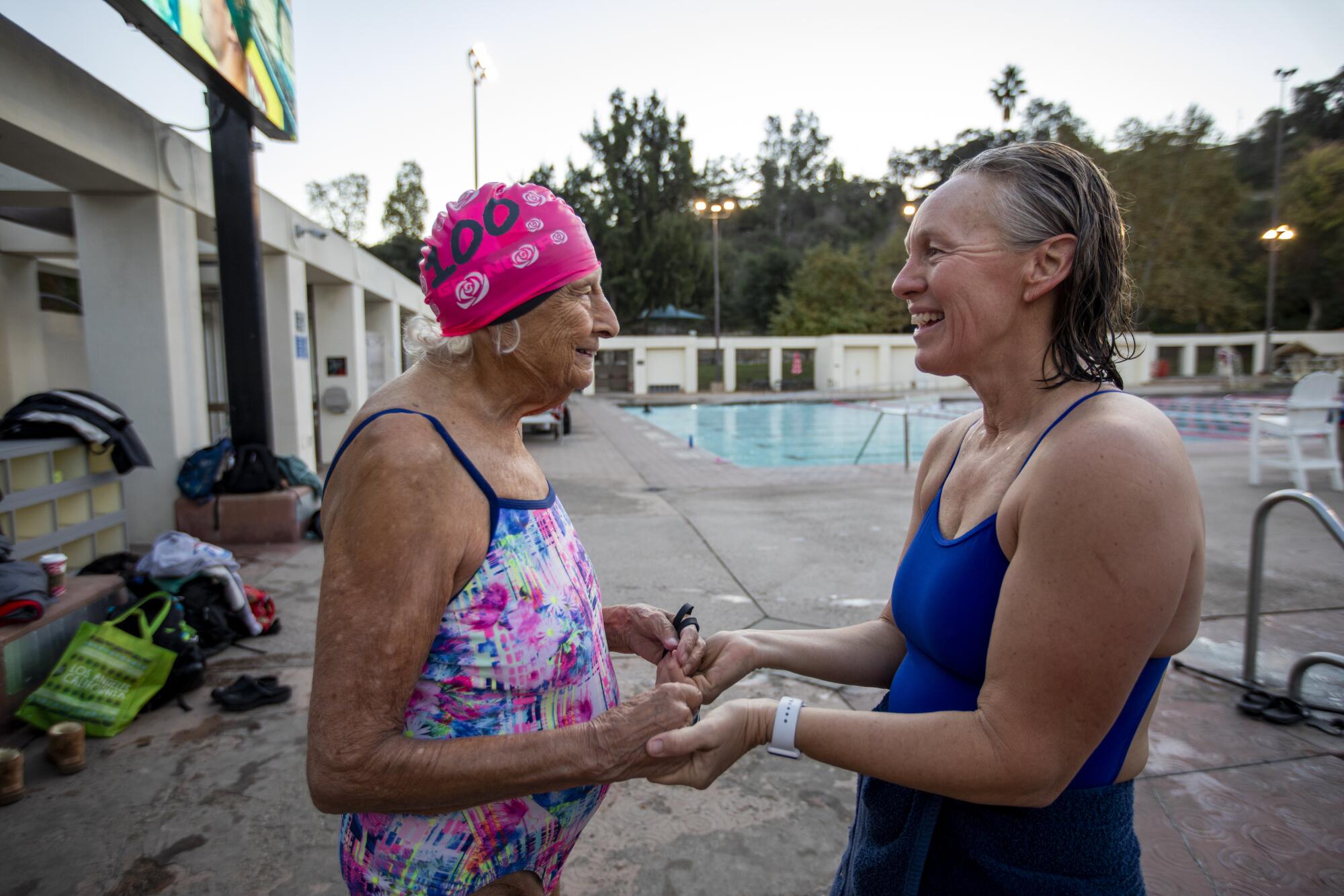 Swim coach Cheryl Simmons greets Maurine Kornfeld before practice.