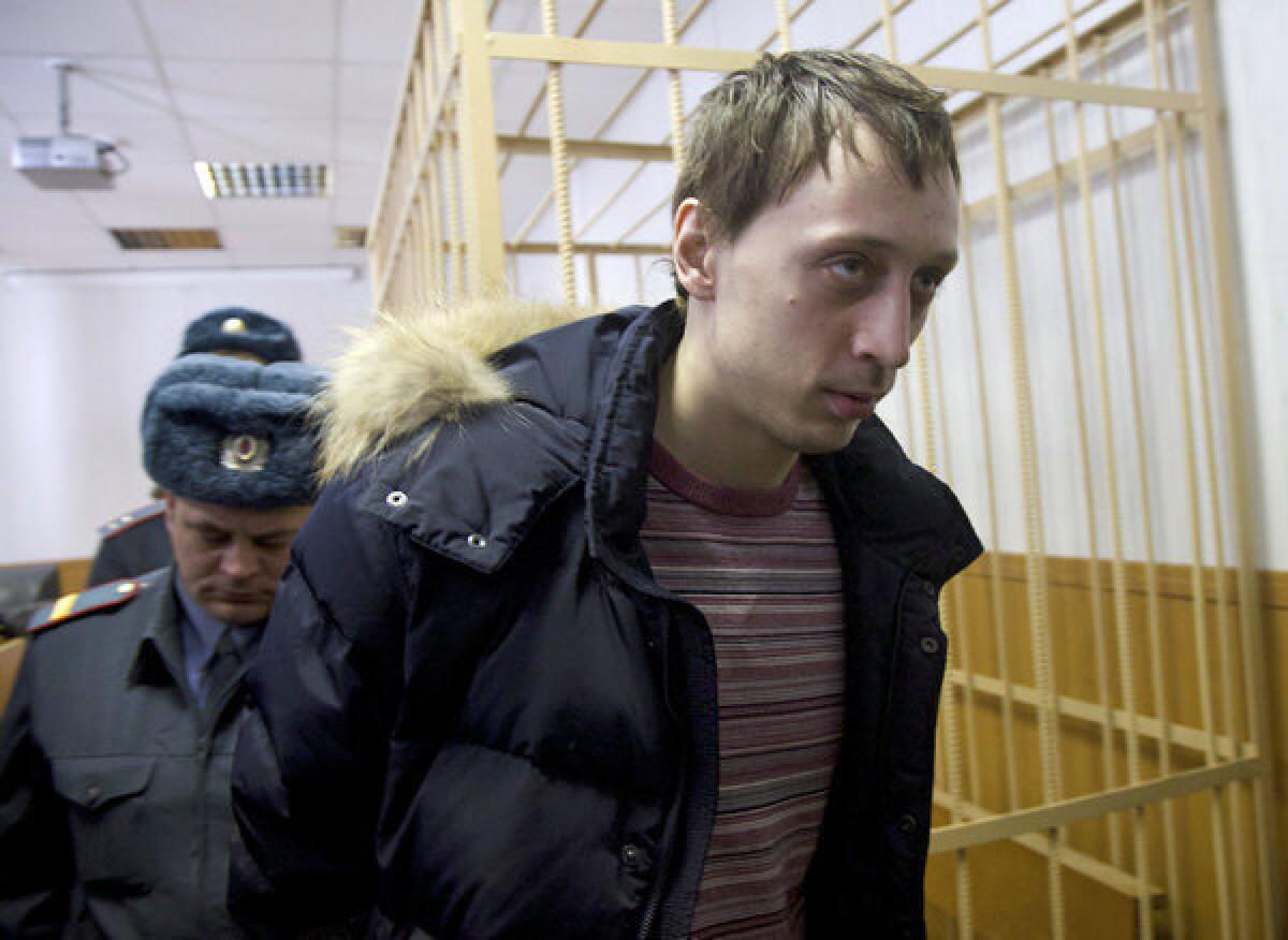 Pavel Dmitrichenko is escorted out of a Moscow courtroom on Thursday. The star dancer is accused of masterminding an acid attack that injured the Bolshoi Ballet's artistic director.