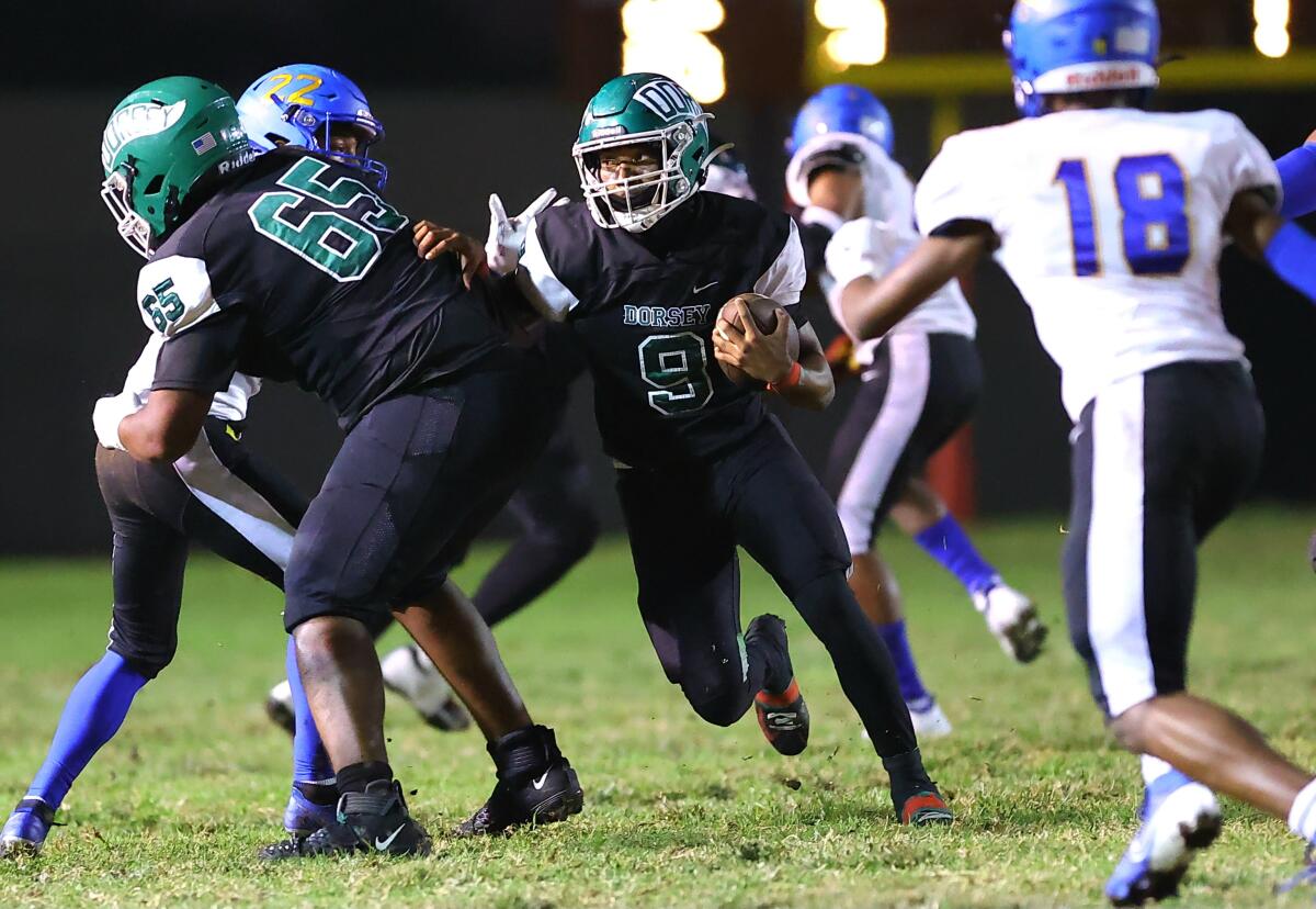 Dorsey running back Ja'Marion Broughton follows a block through the line of scrimmage in a win over Crenshaw on Friday night.