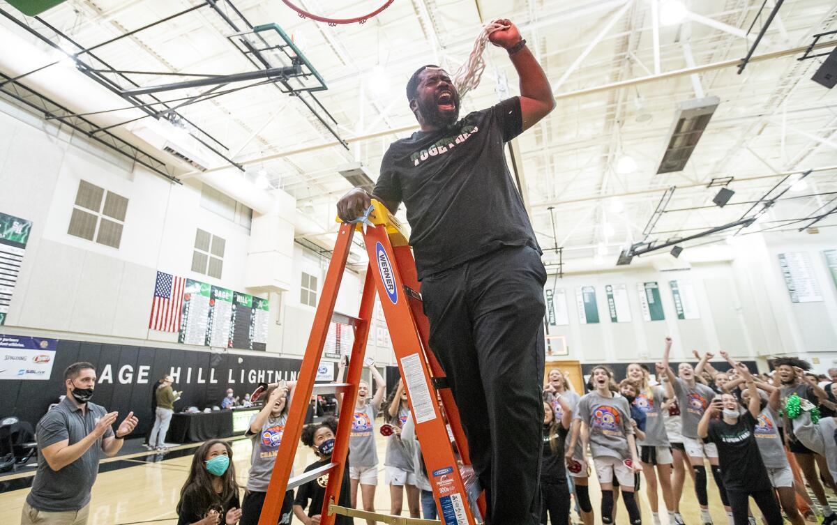 Sage Hill's head coach Kerwin Walters cuts down the net following a 62-55 win over Ontario Christian.