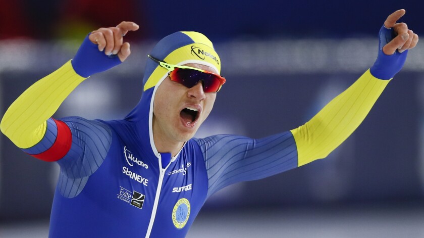Sweden's Nils van der Poel celebrates setting a new world record on the men's 10,000 meters race of the World Championships Speedskating Single Distance at the Thialf ice arena in Heerenveen, northern Netherlands, Sunday, Feb. 14, 2021. (AP Photo/Peter Dejong)