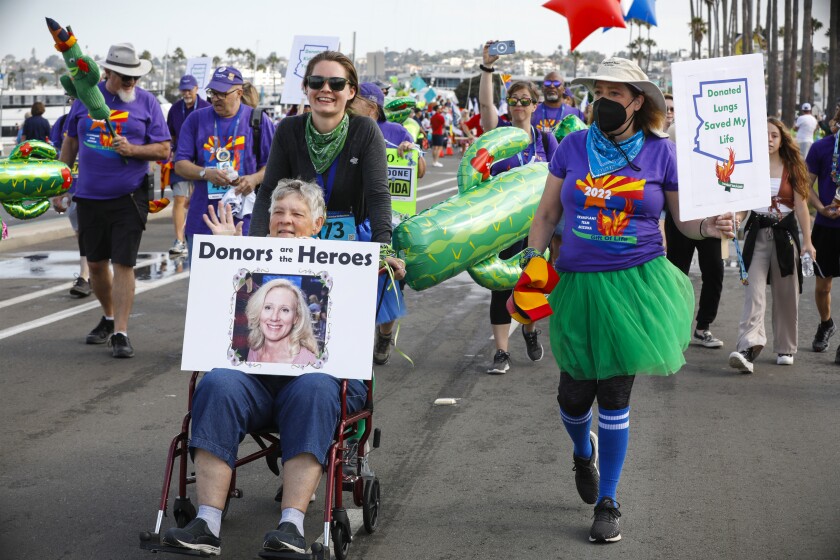 Lynn Stackrow is pushed by her granddaughter Daniele Stackrow as they walk in the Transplant Games of America parade
