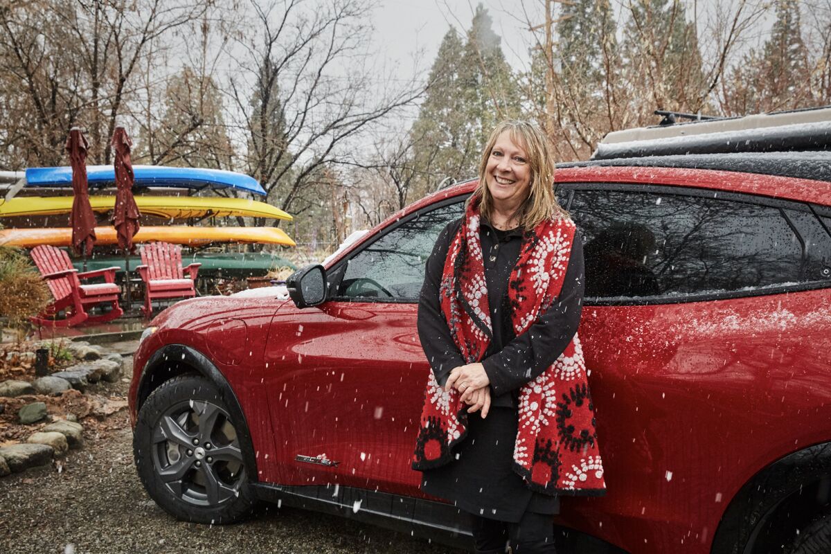 Kay Ogden with her electric vehicle at her home in Round Valley on March 21, 2023. Photo by Lou Bank for CalMatters