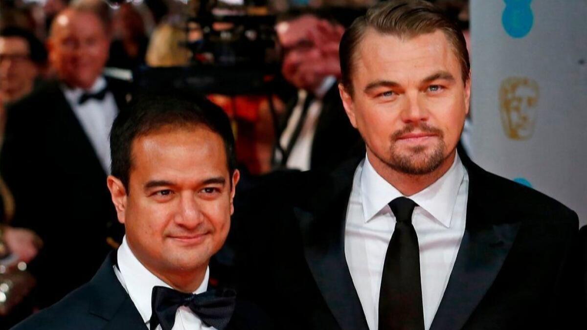 "The Wolf of Wall Street" producer Riza Aziz, at left with the film's star Leonardo DiCaprio, attends a 2014 awards show.