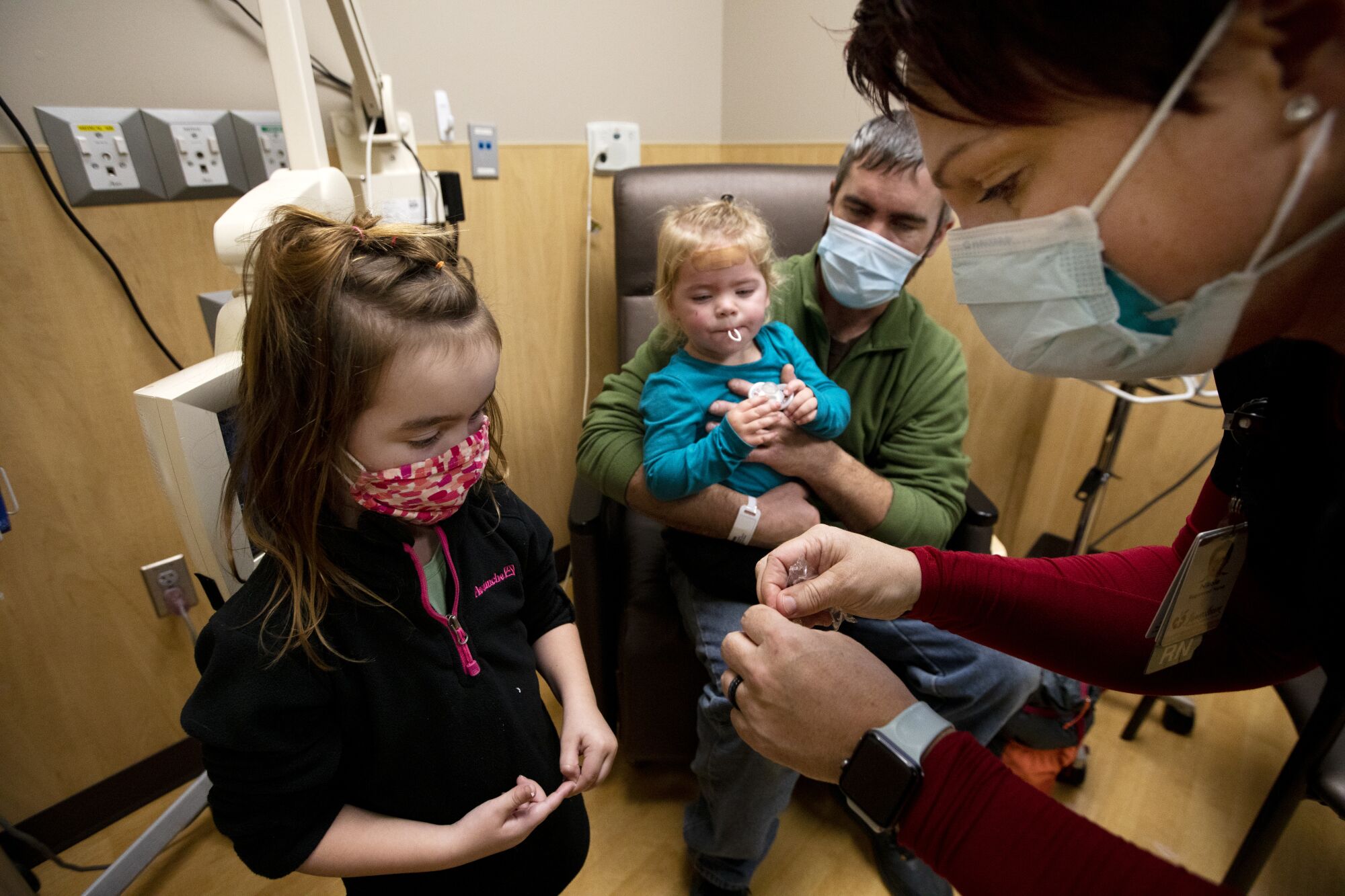 Nurse Nikole Hoggarth gives a sucker to children at Jamestown Regional Medical Center.