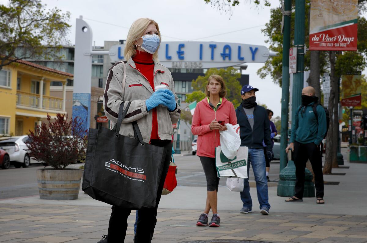 Gail Donahue stood in line with other customers who were all spaced out for the required social distancing at the Farmers Market on Saturday. To allow for the required social distancing, the market was limited to 50 customers at a time.