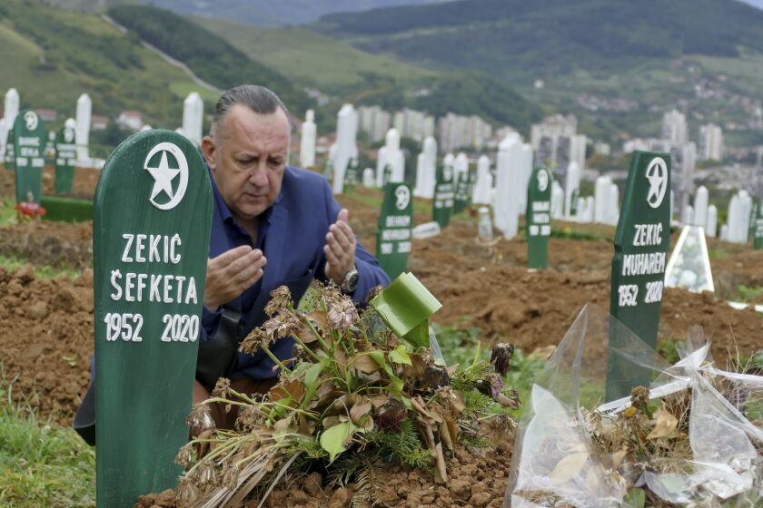 Tarik Svraka visits the graves of relatives who died of COVID-19 complications in Zenica, Bosnia.